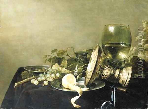 A Vanitas still life with a partially peeled lemon, grapes and olives on pewter dishes, an overturned gold tazza, an upturned glass Oil Painting - Pieter Claesz.